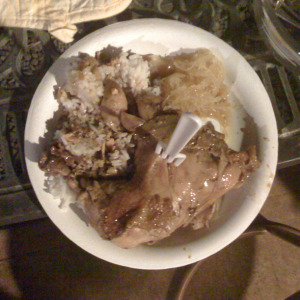 Adobo served with rice, green salad and pickled green papaya