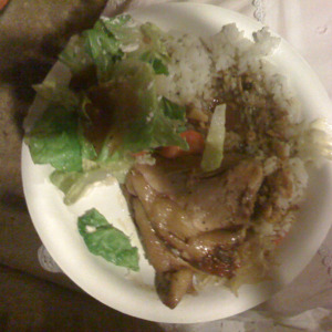 Adobo served with rice, green salad and pickled green papaya